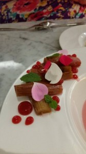 rhubarb and rose petals on the edge of a plate