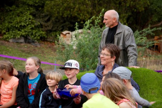 Grant Lyon and Celia Wade-Brown pose with treasure-hunters after the unveiling of "Yeah Nah".