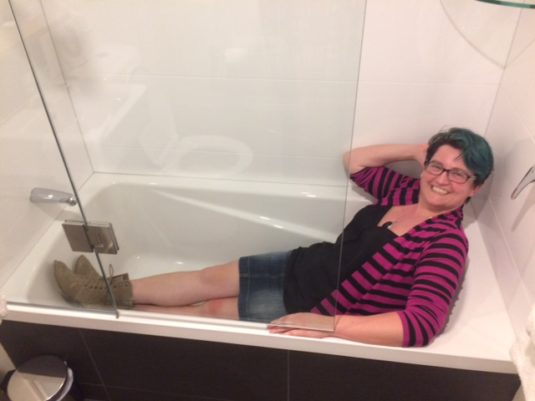 an average size person in a fairly small bathtub