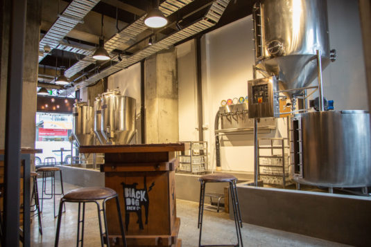 downstairs room with big stainless steel brewing tanks