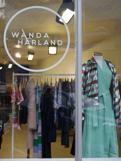 window of wanda harland showing colourful clothing