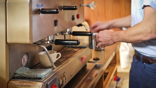 Image of Richard Legg operating an espresso machine.