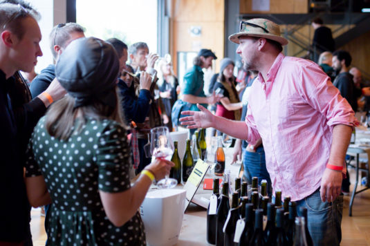 Man from Cambridge Road talking about his wines to a crowd